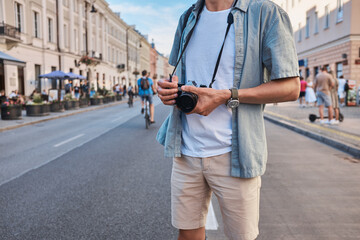 Male tourist shooting on the street, summer Eurotrip