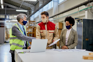 Wall Mural - Woodworking company managers communicating with male worker at production facility.