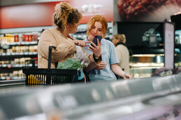 Wall Mural - Shopper getting help from store assistant