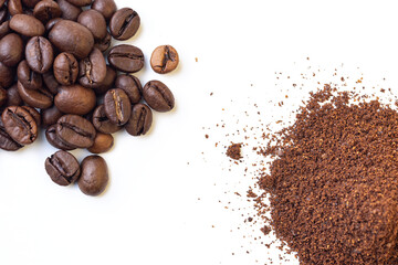 A pile of whole roasted coffee beans and another pile of grounded coffee on an isolated white background, from a high angle view covering the corners of the frame. 