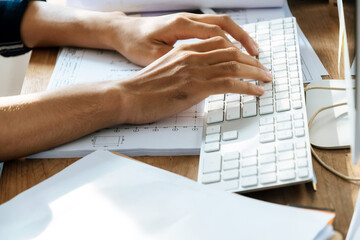 businessman or construction worker hand working about finance business on keyboard computer at home 