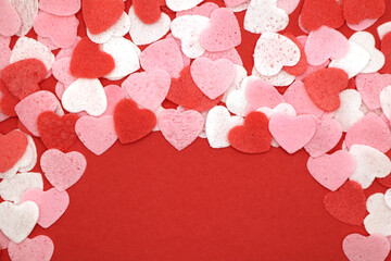 Wall Mural - Red pink and white hearts on a red background. Valentine's day concept. Selective focus. Postcard. Background.