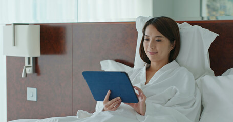 Sticker - Woman use of tablet computer and sit on bed