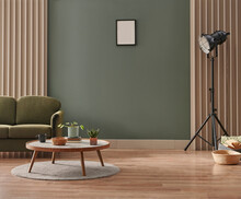Green Living Room Wall Background With Grey Decorative Chair, Lamp Frame Middle Table And Poster Style.