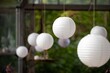 white paper lanterns and decorations hanging in wedding hall