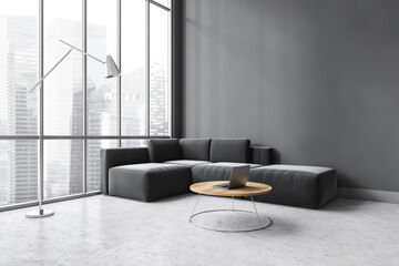 Dark living room with black sofa on grey marble floor with coffee table