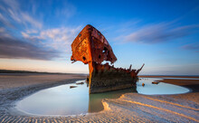 Shipwrecked Off The Coast Of Ireland, An Shipwreck Or Abandoned Shipwreck,,boat Wreck Sunset Light At The Beach, Wrecked Boat Abandoned Stand On Beach Or Shipwreck