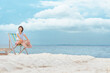 Asian woman Sit on a beach chair,Refreshment and enjoyment with nature concept.
