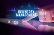 © ra2 studio - Finger touching tablet with charts and INVENTORY MANAGEMENT inscription, business concept