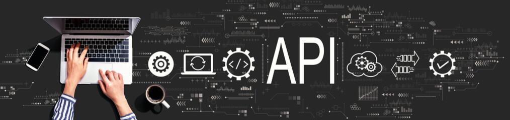api - application programming interface concept with person using a laptop computer