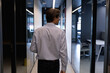 © Wavebreak Media - Caucasian businessman walking holding a laptop in a modern office