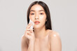 © 220 Selfmade studio - Attractive Charming Asian young woman smile and using tissue with toner for cleaning make up feeling so fresh and clean with healthy skin,isolated on white background,Beauty Cosmetics Concept