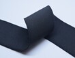 Black Knit Elastic Spool for needlework of the cloth insulated on black background.