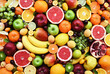 Fresh ripe organic fruits from market: apple and orange, grapefruit and banana, grape and apricot