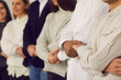 © Studio Romantic - Team of young mixed race business people, students or company employees standing together and holding hands, showing unity and supporting each other. Strong community, human power, teamwork concepts