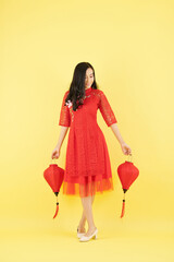 Poster - Beautiful young Asian woman holding red paper lanterns she prepaerd for Chinese New Year celebration