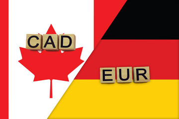 Canada and Germany currencies codes on national flags background