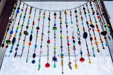 Handmade Sun Catcher With Crystals And Beading Window Curtains Hanging On Winter Frosty Window.