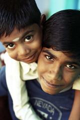 Two happy Indian teen boys looking to the camera.