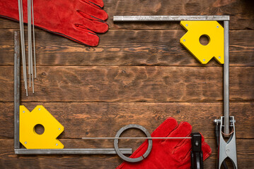 Canvas Print - Welding machine terminals and magnetic corners with metal frame on the workbench background with copy space.