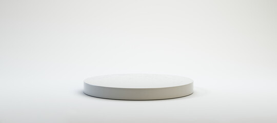 circular white pedestal in front of white background