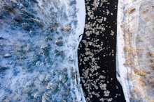 Aerial View Of A Blue And Green River With Snow And Crushed Ice During An Ice Drift In Winter