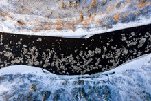 Aerial View Of A Blue And Green River With Snow And Crushed Ice During An Ice Drift In Winter