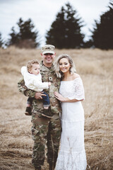 Sticker - Young family portrait - a soldier father holding his son and a beautiful young wife