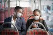 © Rawpixel.com - Business couple wearing mask on the bus while traveling on public transportation in the new normal