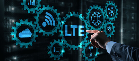 Wall Mural - LTE concept on Server Room Background. Young business man presses with a finger LTE.