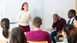 © JackF - Group of students attentively listening to lecture of female teacher in classroom