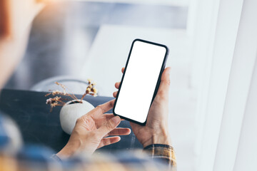 cell phone blank white screen mockup.woman hand holding texting using mobile on desk at office.backg