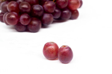 two red grape with bunch of grapes