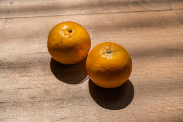 oranges in the afternoon light on wooden table