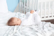 © Pixel-Shot - Cute little baby lying on bed at home