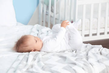 Sticker - Cute little baby lying on bed at home