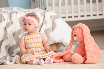 Poster - Cute little baby sitting on carpet at home