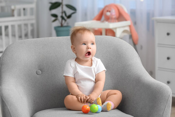 Poster - Cute little baby sitting in armchair at home