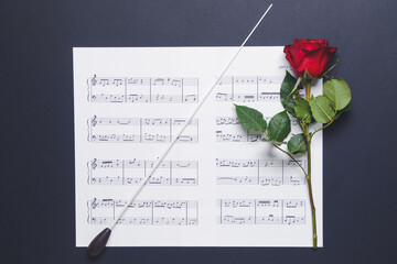 Poster - Music sheets, rose and conductor's stick on dark background