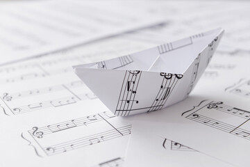 Wall Mural - Paper boat with notes on music sheets