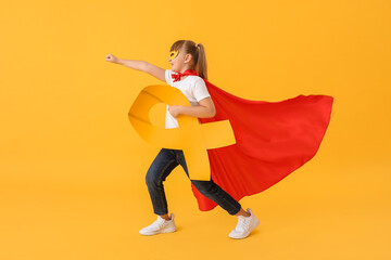 Poster - Little girl wearing superhero costume and with golden ribbon on color background. Childhood cancer awareness concept