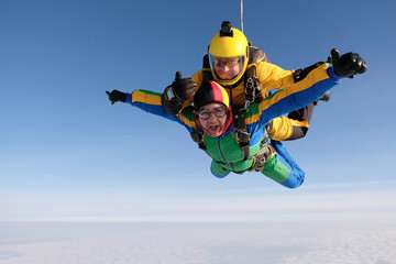 Skydiving. Tandem jump. Two guys are flying in the sky.