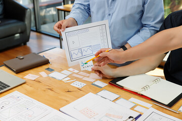 Graphic designers work together with UX UI designer planning application template layout framework for mobile phone computer mobile