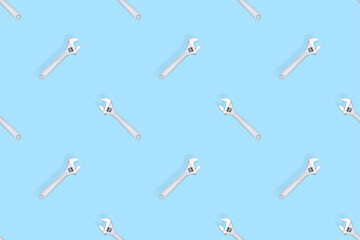 Adjustable metal wrench seamless pattern. Adjustable metal wrench on a colored background.