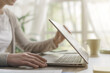 © StockPhotoPro - Woman sitting at desk and working with her laptop