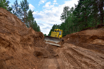 Poster - Dozer during clearing forest for construction new road . Yellow Bulldozer at forestry work Earth-moving equipment at road work, land clearing, grading, pool excavation, utility trenching