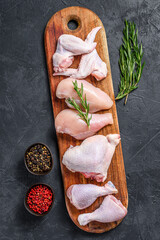 Wall Mural - Fresh raw chicken meat and chicken parts. Black background. Top view