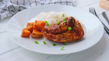 Canvas Print - Baked chicken breast with rice and sweet potatoes on a white plate. Diet food concept.