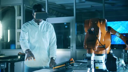 Wall Mural - african ethnicity engineer in vr-glasses is navigating a robotic mechanism