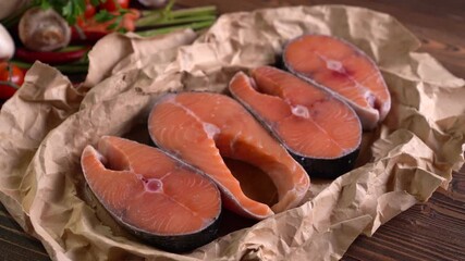 Wall Mural - Fresh raw salmon fish steak with herbs and vegetables on wooden background